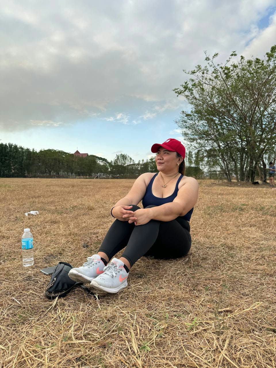 Ivy seated outdoors on an open grassy field