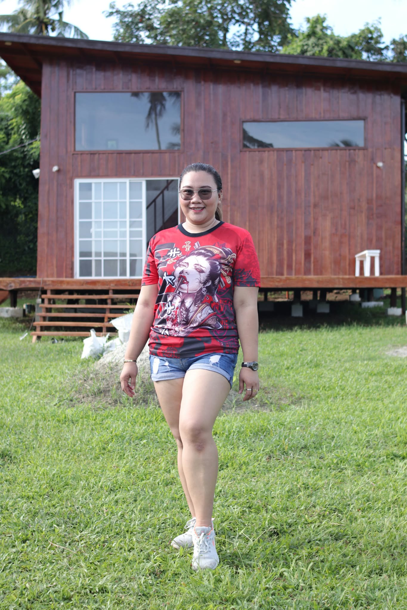 Ivy standing on grass in front of a wooden building