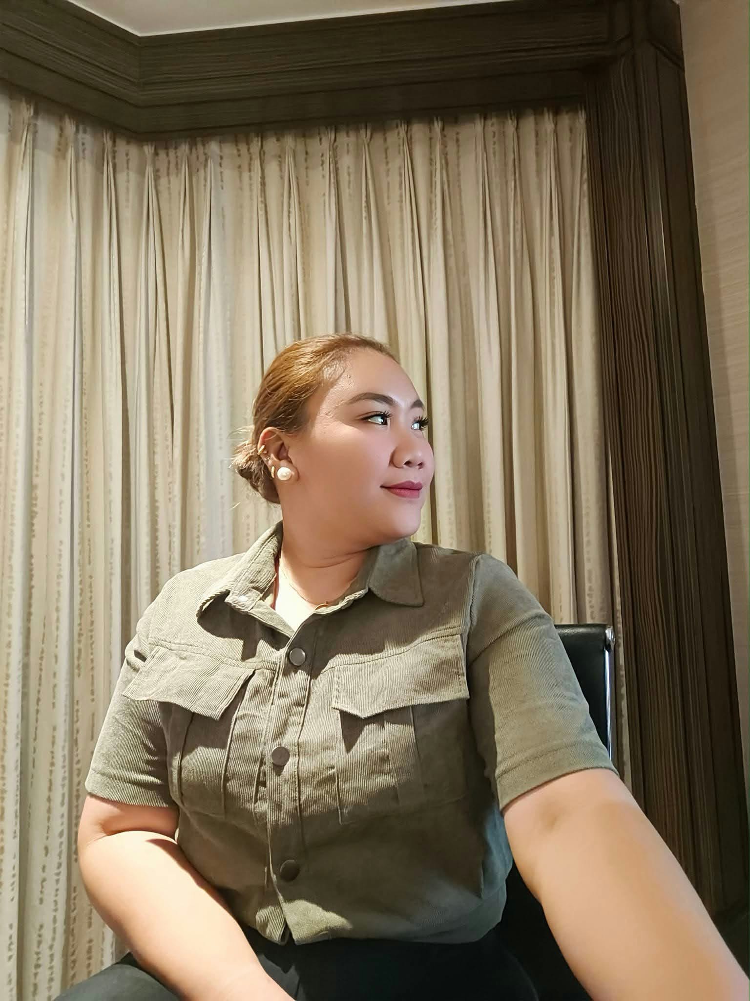 Ivy looking to the side in an olive green shirt