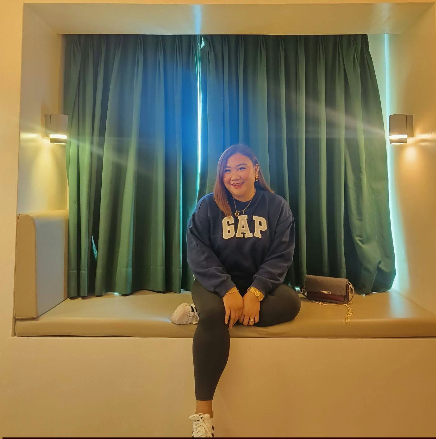 Ivy seated in a warmly lit room